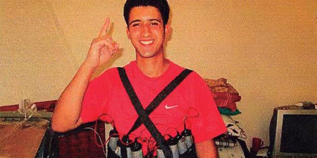 Youssef Aalla, who participated in several attacks in Barcelona and Cambrils on Aug. 17, 2017, poses with an explosive belt at a house in Alcanar, Spain.
