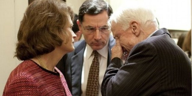 Dec. 9: Sen. John Barrasso, R-Wyo., talks with Alaska Sen. Lisa Murkowski and Arizona Sen. John McCain in a Senate hallway. (AP)