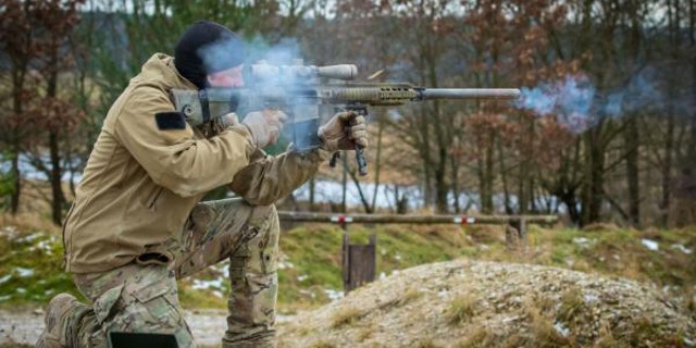A U.S. Army Special Forces Soldier assigned to 10th Special Forces Group (Airborne) fires an M110 Semi-Automatic Sniper System during weapons training in Grafenwoehr, Germany, Dec., 12, 2017. (Photo by Staff Sgt. Jessica Nassirian/U.S. Army)