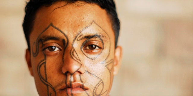 An imprisoned member of street gang Barrio 18 poses for a photograph at the Izalco prison, about 65 km (40 miles) from San Salvador.
