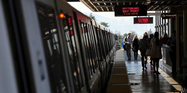 Passengers depart from a Bay Area Rapid Transit (BART) train in Oakland, California.