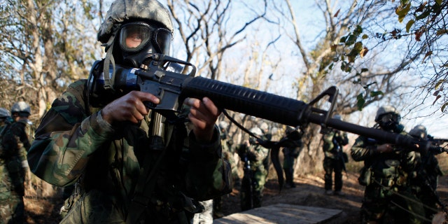 A U.S. Army recruit practices securing the area during a chemical weapons exercise at basic training at the Fort Sill Army Post.