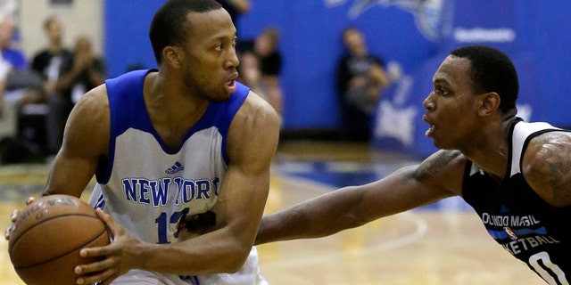 FILE - This is a Wednesday, July 6, 2016 file photo of New York Knicks' Akil Mitchell, left, as he looks to pass the ball around Orlando Magic White's Treveon Graham during the first half of an NBA summer league basketball game in Orlando, Fla. American basketball player Akil Mitchell's eye popped out of its socket after he was poked in the face while going for a rebound during a game in New Zealand Thursday Jan. 26, 2017 .(AP Photo/John Raoux, File)