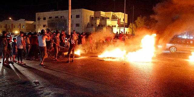 Iraqi protesters demanding services and jobs burn tires during a demonstration in Basra, 340 miles southeast of Baghdad, Iraq, July 13, 2018.