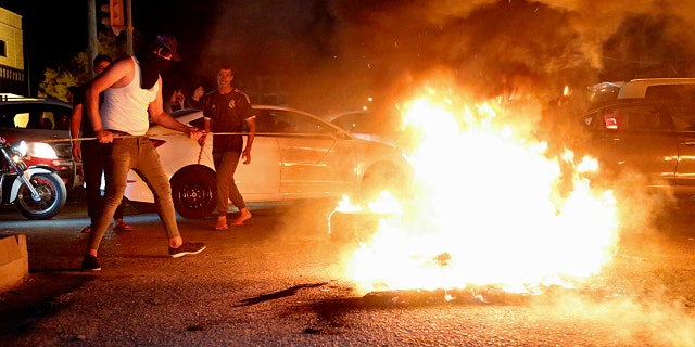 Iraqi protesters demanding services and jobs burn tires during a demonstration in Basra, 340 miles southeast of Baghdad, Iraq, July 13, 2018.