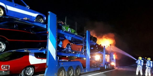 A transporter carrying a dozen novelty cars including a BATMOBILE caught fire - burning a number of vintage vehicle to bits. See SWNS story SWFIRE; The lorry was travelling westbound on the M4 near Bath on Wednesday night when it went up in flames. Highways England was forced to shut two lanes of the motorway as firefighters battled the blaze into the early hours of Thursday. It is not know the extent of damage the cars suffered, but Highways England said a number of the specialists cars along with the transporter cab had been destroyed. The truck had been transporting a number of classic cars including a âDukes of Hazzardâ General Lee, Batmobile, âTransformersâ Ford Mustang and âStarsky and Hutchâ Ford Torino.
