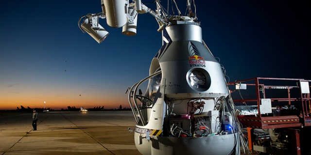 A crane holds Felix Baumgartner's capsule at the flight line in Roswell, N.M., on Oct. 9, 2012, before the daredevil attempted his record-breaking leap from the stratosphere.