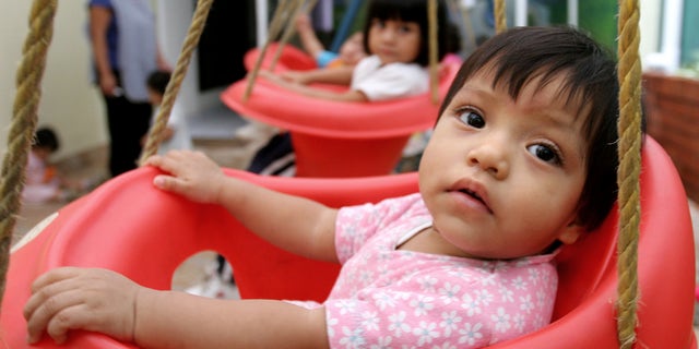 In this June 12, 2006 file photo, children waiting for adoptions are seen in a house held by a lawyer specialized in adoptions in Guatemala City, Guatemala. The number of international adoptions has plummeted to its lowest point in 15 years, a steep decline attributed largely to crackdowns against baby-selling, a sputtering world economy and efforts by countries to place more children with domestic families. (AP Photo/Alexandre Meneghini, File)