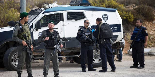 Israeli border police officers secure a checkpoint near the West Bank town of Nablus, Friday, Oct. 30, 2015. (AP Photo/Ariel Schalit)