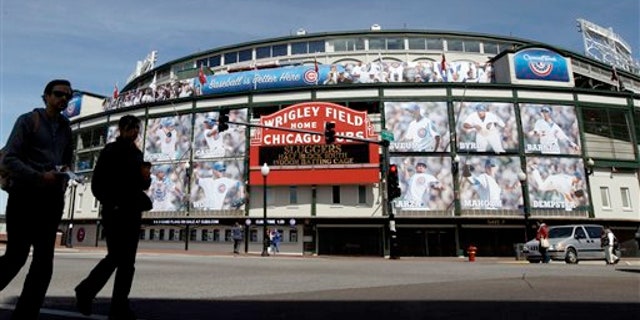 April 4, 2012: People walk by the Marquee at Wrigley Field
