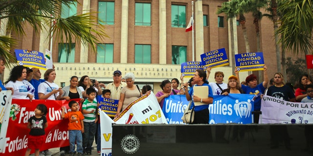 Various human rights organizations gathered outside the federal courthouse in Brownsville, Texas, Thursday, March 19, 2015.  The Justice Department might face sanctions if a federal judge determines its attorneys misled him about whether part of President Barack Obama's executive action on immigration was implemented prior to it being put on hold by the judge. U.S. District Judge Andrew Hanen last month halted Obama's plan. The president's plan would spare from deportation up to 5 million people in the U.S. illegally. (AP Photo/The Brownsville Herald, Yvette Vela)
