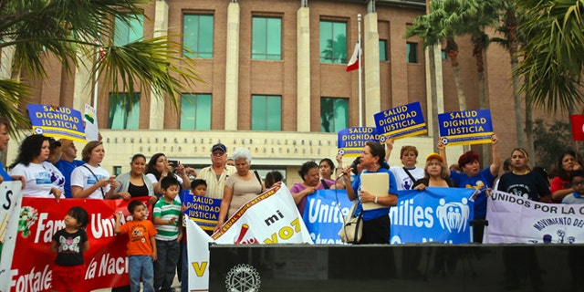 Various human rights organizations gathered outside the federal courthouse in Brownsville, Texas, Thursday, March 19, 2015. The Justice Department might face sanctions if a federal judge determines its attorneys misled him about whether part of President Barack Obama's executive action on immigration was implemented prior to it being put on hold by the judge. U.S. District Judge Andrew Hanen last month halted Obama's plan. The president's plan would spare from deportation up to 5 million people in the U.S. illegally. (AP Photo/The Brownsville Herald, Yvette Vela)
