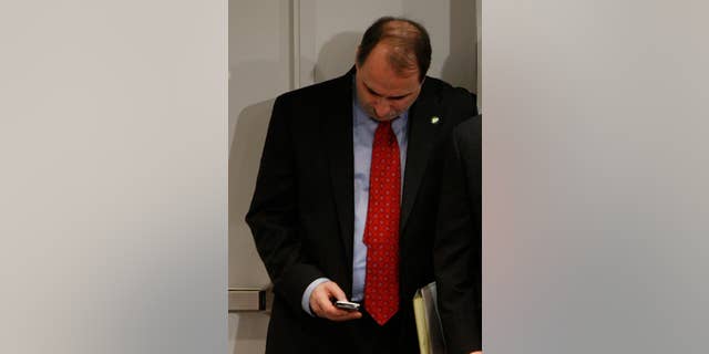 In this Jan. 9, 2009 file photo, David Axelrod checks his BlackBerry E-Mail device at the White House (AP Photo/Charles Dharapak. File)