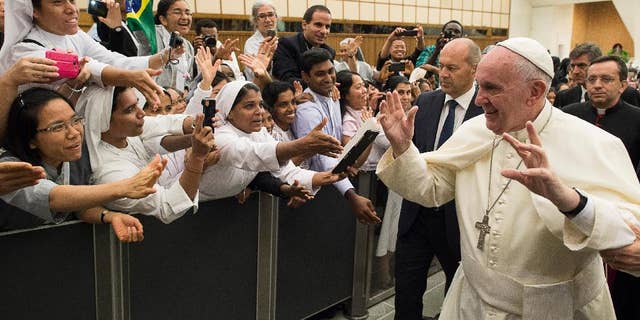 Pope Francis arrives for a meeting wit a group of young people who is participating in the International Congress for Young People in Consecrated Life, taking place in Rome this week, at the Vatican Thursday, Sept. 17, 2015. (L'Osservatore Romano/Pool Photo via AP)
