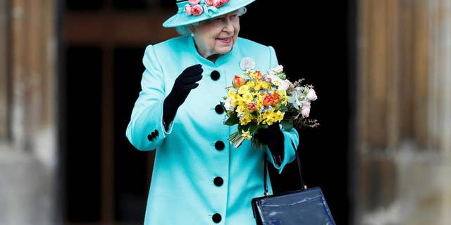 Britain's Queen Elizabeth waves to onlookers as she leaves the Easter Sunday service at St George's Chapel at Windsor Castle in Berkshire, England, Sunday, April 16, 2017. (Peter Nicholls/Pool Photo via AP)