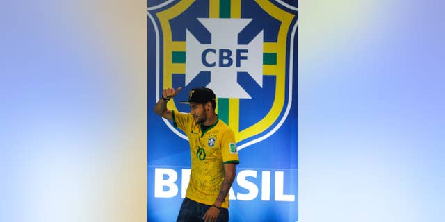 Brazil's Neymar gives the thumbs up, as he leaves after a press conference at the Granja Comary training center in Teresopolis, Brazil, Thursday, July 10, 2014. The Brazilian soccer star is back on his feet after suffering a broken vertebrae during a World Cup soccer match against Colombia. Brazil will be disputing a third place finish, without its star on Saturday. (AP Photo/Leo Correa)