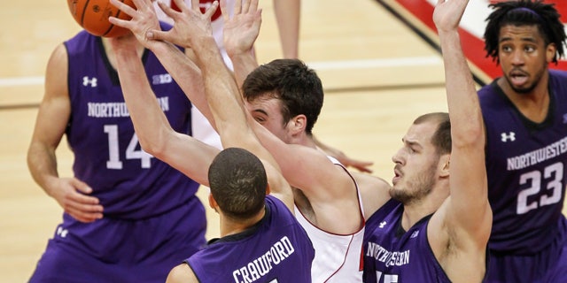 Northwestern's Drew Crawford (1) and Nikola Cerina (45) trap Wisconsin's Frank Kaminsky during the second half of an NCAA college basketball game Wednesday, Jan. 29, 2014, in Madison, Wis. Northwestern upset Wisconsin, 65-56. (AP Photo/Andy Manis)