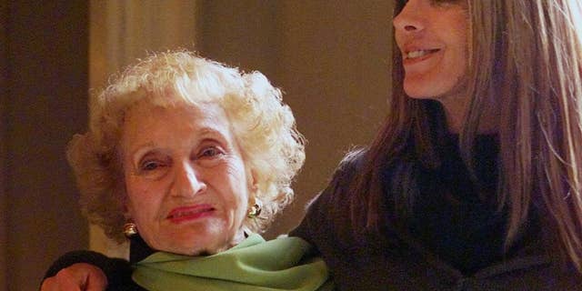 FILE- In this Jan. 9, 2001, file photo, Dr. Ruth Gruber, left, and actress Natasha Richardson pose for a photo at the Ritz Carlton Huntington Hotel in Pasadena, Calif. Gruber, the journalist and humanitarian whose long, trailblazing life included helping to bring Jewish refugees to the United States during World War II, has died. She was 105. Gruber died on Thursday, Nov. 17, 2016, at her home in Manhattan, according to her editor, Philip Turner. (AP Photo/Damian Dovarganes, File)