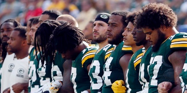 Green Bay Packers players linked arms Sunday during the national anthem.