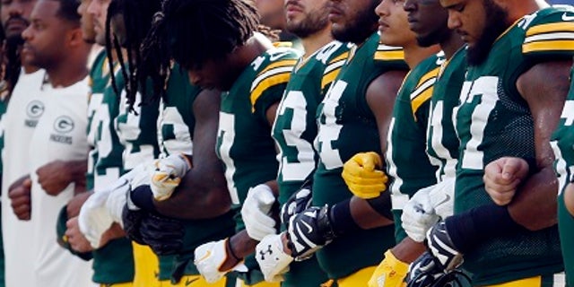 Green Bay Packers players linked arms Sunday during the national anthem.