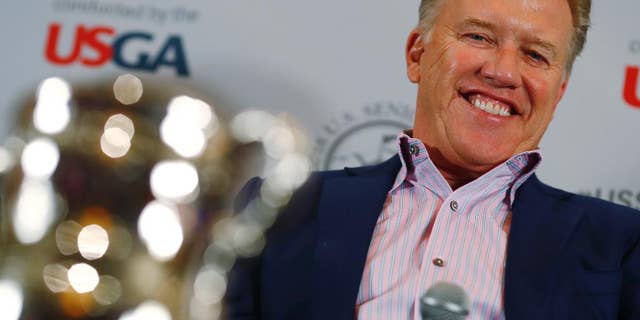 Denver Broncos general manager John Elway jokes with reporters after he was introduced as the honorary chairman of the 39th U.S. Senior Open, which will be held at the Broadmoor Golf Club in Colorado Springs, Colo., during a news conference at one of the retired football player's steakhouses on Tuesday, Nov. 15, 2016, in Denver. The 2018 U.S. Senior Open will run from June 28 through July 1 on the Broadmoor's East Course. (AP Photo/David Zalubowski)