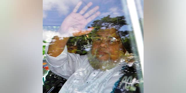 FILE - In this July 17, 2013, file photo, Ali Ahsan Mohammad Mojaheed, the secretary-general of Bangladesh's Jamaat-e-Islami party, waves from a police vehicle as he is brought to court in Dhaka, Bangladesh. Bangladesh's Supreme Court on Tuesday, June 16, 2015, upheld his death sentence for war crimes and crimes against humanity during the country's independence war against Pakistan in 1971. (AP Photo, File)