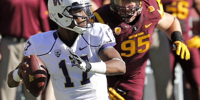 Washington quarterback Keith Price (17) throws as Arizona State defensive end Gannon Conway (95) defends during the first half of an NCAA college football game, Saturday, Oct. 19, 2013, in Tempe, Ariz. (AP Photo/Matt York)
