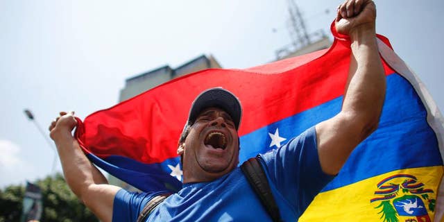 A man shouts anti-government slogans during a protest in Caracas, Venezuela, Thursday, April 20, 2017. Venezuela's opposition is calling for another day of protests against President Maduro after mass demonstrations Wednesday resulted in two deaths. (AP Photo/Ariana Cubillos)