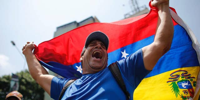 A man shouts anti-government slogans during a protest in Caracas, Venezuela, Thursday, April 20, 2017. Venezuela's opposition is calling for another day of protests against President Maduro after mass demonstrations Wednesday resulted in two deaths. (AP Photo/Ariana Cubillos)