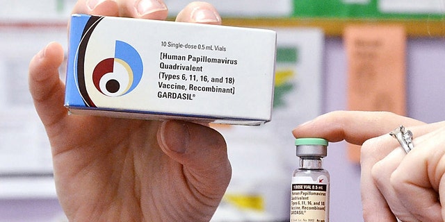 A nurse holds up a vial and box for the HPV vaccine, brand name Gardasil, at a clinic in Kinston, N.C.