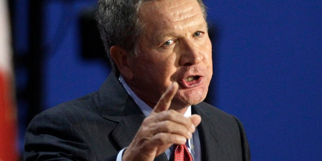 FILE - In this Aug. 28, 2012 file photo, Ohio Governor John Kasich addresses delegates during the Republican National Convention in Tampa, Fla. Kasich is on a what he calls a reluctant "trade mission" to the World Econonimc Forum in Davos, Switzerland, where he is courting business opportunities. (AP Photo/Charlie Neibergall, File)