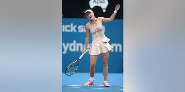 Caroline Wozniacki of Denmark reacts while playing Barbora Zahlavova Strycova of the Czech Republic during their match at the Sydney International tennis tournament in Sydney, Monday, Jan. 12, 2015. Wozniacki retired from the match with a wrist injury. (AP Photo/Rick Rycroft)