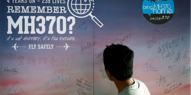 A man looking at a message board remembering the MH370 passengers on March 3, 2018, four years after the jet vanished.