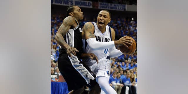 San Antonio Spurs' Kawhi Leonard, left, defends against a drive to the basket by Dallas Mavericks' Shawn Marion, right, in the first half of Game 6 of an NBA basketball first-round playoff series on Friday, May 2, 2014, in Dallas. (AP Photo/Tony Gutierrez)