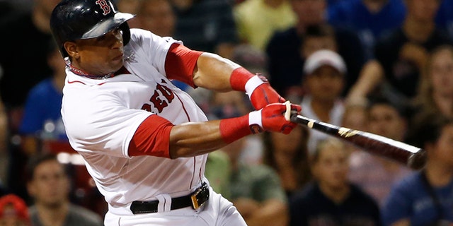 FILE - In this Sept. 6, 2014, file photo, Boston Red Sox's Yoenis Cespedes follows through on a RBI double against the Toronto Blue Jays during the third inning of a baseball game at Fenway Park in Boston. The Red Sox have agreed to trade outfielder Yoenis Cespedes to the Detroit Tigers for pitcher Rick Porcello, according to a person familiar with the negotiations. Right-handed pitching prospect Alex Wilson also will go to Detroit as part of the trade, the person said Thursday, Dec. 11, 2014, speaking on condition of anonymity because no announcement had been made. (AP Photo/Winslow Townson, File)