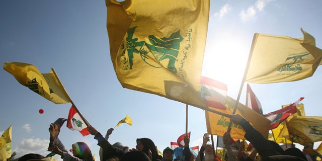 BEIRUT, LEBANON- SEPTEMBER 22: Hezbollah supporters wave flags during a ''Victory over Israel'' rally in Beirut's suburbs on September 22, 2006 in Beirut, Lebanon. Hezbollah leader Sayyed Hassan Nasrallah reportedly said that Hezbollah would not disarm until a Lebanese government capable of protecting the country was in place during the rally. (Photo by Salah Malkawi/Getty Images)