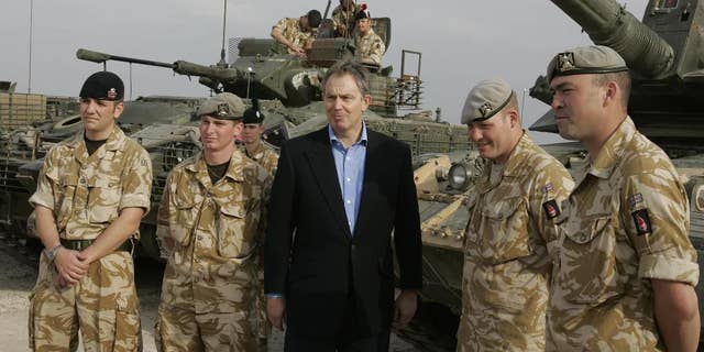FILE- In this Thursday Dec. 22, 2005 file photo, the then Britain's Prime Minister Tony Blair meets soldiers at Shaibah logistics base, Basra, Iraq. Thirteen years after British troops marched into Iraq and seven years after they left a country that's still mired in violence, a mammoth official report, which will be published Wednesday July 6, 2016, is about to address the lingering question: What went wrong? (AP Photo/Kirsty Wigglesworth, File)