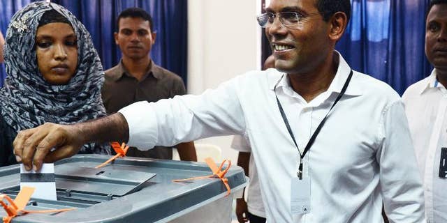 Maldivian former President and Presidential candidate Mohamed Nasheed smiles as he casts his vote at a local polling station in Male on September 7, 2013.