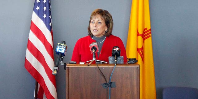 New Mexican Governor Susana Martinez makes announcements regarding gas shortages from the Emergency Operating Center on the National Guard Base just south of Santa Fe, N.M., on Thursday, Feb. 3, 2011.  Secretary of Homeland Security and Emergency Management Michael Duvall, left, and  Major General Kenny C. Montoya, right, look on.    Martinez has declared a state of emergency as thousands of New Mexico residents lost natural gas service due to the bitter cold.  Martinez sent all nonessential state workers home for the day Thursday, and urged all residents to turn down their thermostats, bundle up and shut off appliances they don't need for the next 24 hours.   (AP Photo/The New Mexican, Natalie GuillÃ©n)