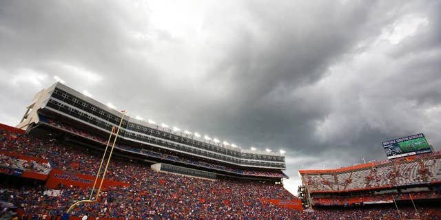 Dark clouds move over Ben Hill Griifin Stadium at Florida Field during a weather delay before the start of an NCAA college football game between Florida and Idaho in Gainesville, Fla., Saturday, Aug. 30, 2014. (AP Photo/John Raoux)