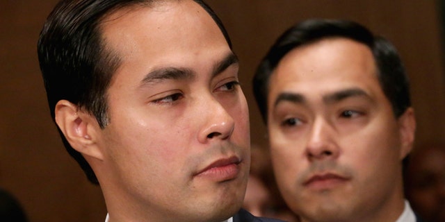 WASHINGTON, DC - JUNE 17: Mayor Julian Castro (L) testifies during his confirmation hearing before the Senate Banking, Housing and Urban Affairs Committee with his twin brother, Rep. Joaquin Castro (D-TX), in the background June 17, 2014 in Washington, DC. The current mayor of San Antonio, Texas, Castro has not faced serious opposition in the Senate. (Photo by Chip Somodevilla/Getty Images)