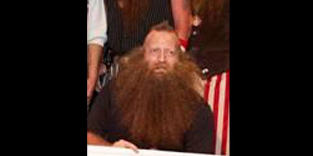 Jeff Langham accepts a check for winning the "Just for Men National Beard & Moustache Championships."