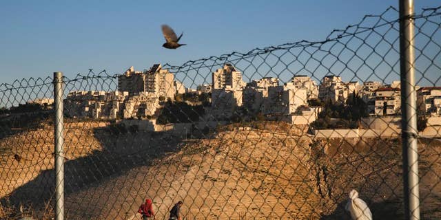 Palestinian laborers work at a construction site in a new housing project in the Israeli settlement of Maale Adumim, near Jerusalem, Tuesday, Feb. 7, 2017. A Palestinian Cabinet minister on Tuesday called on the international community to punish Israel for a contentious new law, just hours after the Israeli parliament adopted the bill to retroactively legalize thousands of West Bank settlement homes built unlawfully on private Palestinian land.(AP Photo/Oded Balilty)