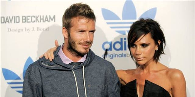 David Beckham and his wife Victoria arrive at an event to celebrate the launch of the Adidas Originals by Originals David Beckham clothing line designed by James Bond, Wednesday, Sept. 30, 2009, in Los Angeles. (AP Photo/Chris Pizzello)