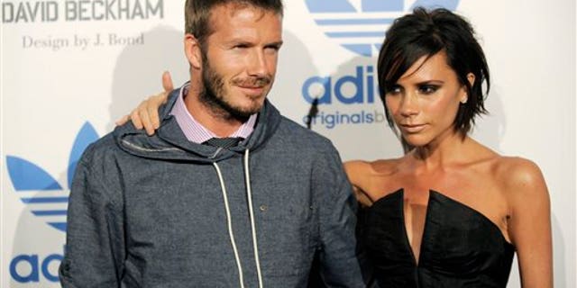 David Beckham and his wife Victoria arrive at an event to celebrate the launch of the Adidas Originals by Originals David Beckham clothing line designed by James Bond, Wednesday, Sept. 30, 2009, in Los Angeles. (AP Photo/Chris Pizzello)