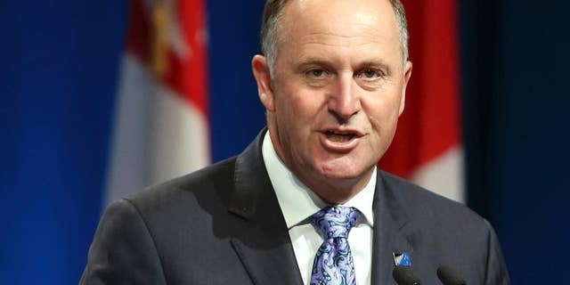 FILE - In this Feb. 4, 2016 file photo, New Zealand Prime Minister John Key speaks to delegates at the signing of the Trans-Pacific Partnership Agreement in Auckland, New Zealand. Key has visited Fiji for the first time since a military coup there a decade ago, although it's clear that political tensions remain. Key and his Fijian counterpart Voreqe Bainimarama met for formal talks Friday, June 10, 2016. (David Rowland/SNPA via AP, File) NEW ZEALAND OUT