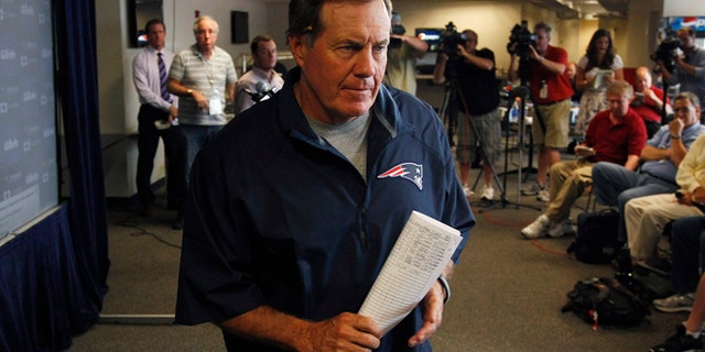 FILE 2013: New England Patriots head coach Bill Belichick leaves a news conference after addressing the media regarding the criminal charges against Aaron Hernandez in Foxboro, Mass.