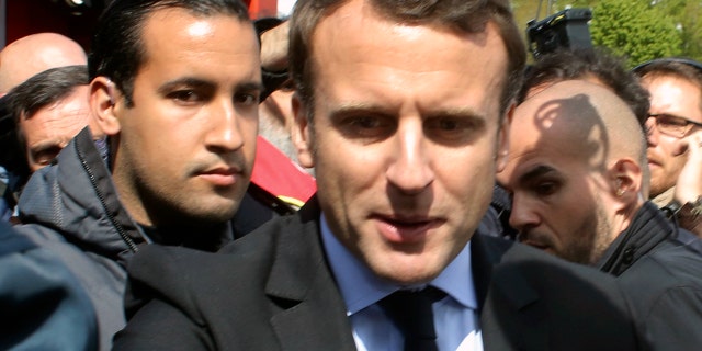 Alexandre Benalla stands with Emmanuel Macron during last year's French presidential election campaign. Benalla, now a top security aide to Macron, was caught on camera beating a May Day protester.