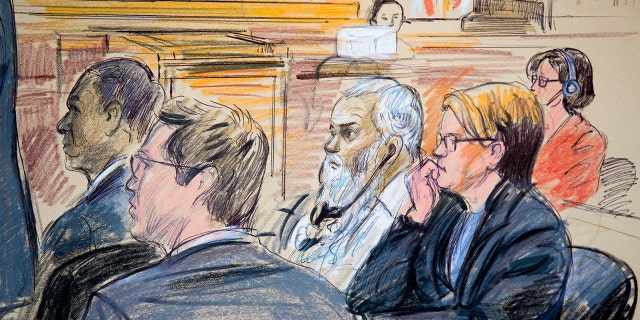 This courtroom sketch shows Ahmed Abu Khattala, third from right, listening to an interpreter through earphones during the opening statement by his defense attorney Jeffery Robinson in federal court in Washington Monday, Oct. 2, 2017.