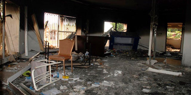 In this Sept. 12, 2012 file photo, glass, debris and overturned furniture are strewn inside a room in the gutted U.S. consulate in Benghazi, Libya, after an attack that killed four Americans, including Ambassador Chris Stevens.